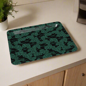 A modern decorative tray with a dark background and interwoven green leaf motifs, perfect for serving or display.