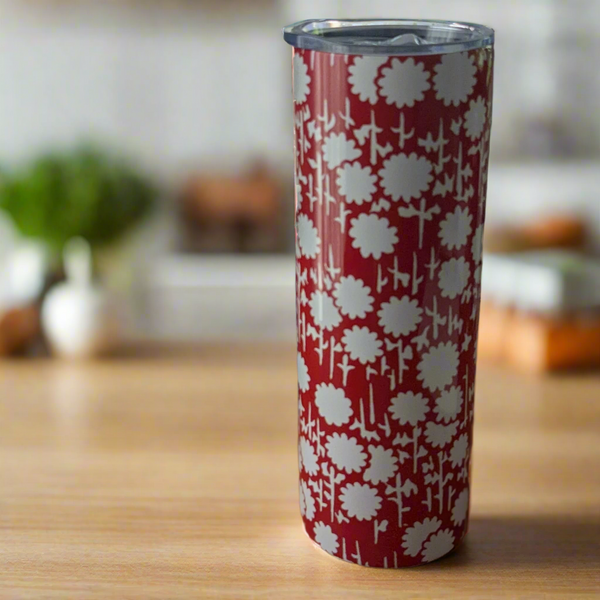 Stainless steel 20 oz tumbler adorned with a bold red floral pattern on a cream-colored background. Comes with a clear lid and two reusable straws for everyday use.