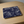 Rectangular tray with rounded corners, featuring a detailed dark blue and white koi fish design, placed on a light wood table.