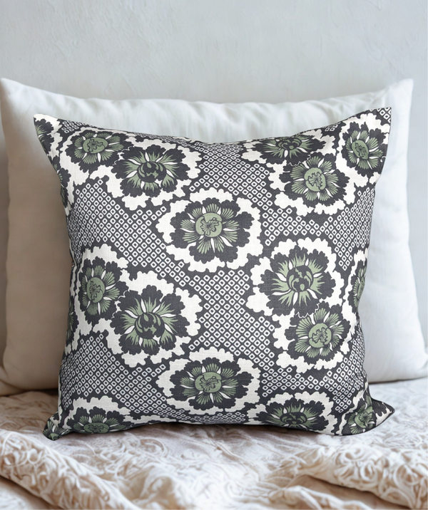 Throw pillow featuring a pattern of stylized dark green and dark blue kiku (chrysanthemum) blossoms, set against an off-white background with a geometric diamond lattice of hollow squares (kanoko).