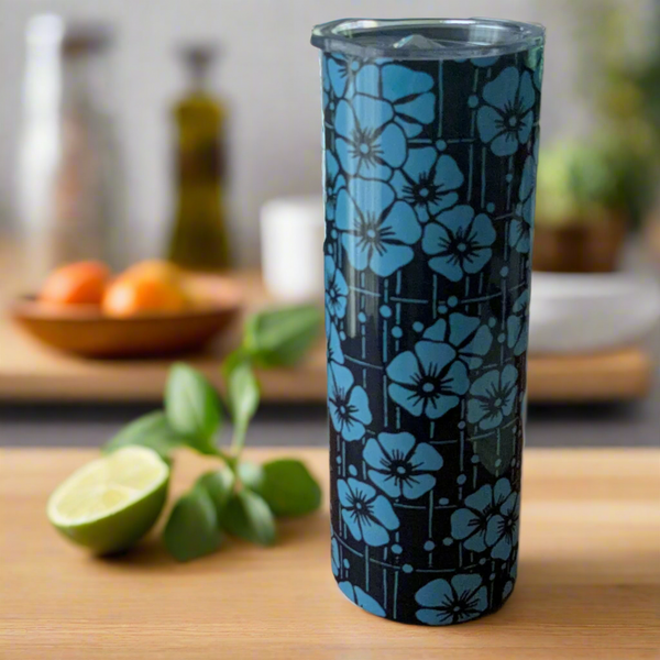 Stainless steel 20 oz tumbler showcasing an intricate blue cherry blossom pattern on a dark navy background. Comes with a clear lid and reusable straw for convenience.