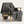Patterned blanket draped over a wooden chair on a white background