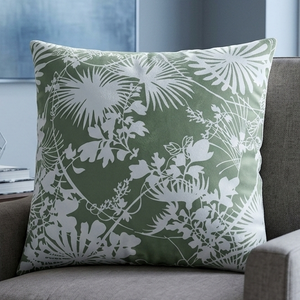 Gray armchair with a green floral pillow in a living room setting.