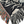 Corner edge of a woven blanket featuring a dynamic, abstract pattern of stylized mist in off-white against a black background. 