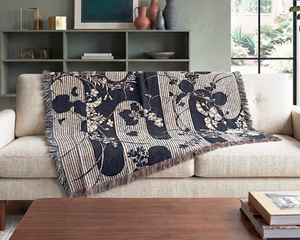 Living room with a beige sofa, wooden coffee table, and decorative items.