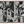 Woven blanket with a dark blue and white Japanese-inspired design. The pattern features a background of alternating vertical stripes and solid black shapes with undulating edges, overlaid with intricate white winding vines, leaves.