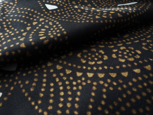 Black and yellow microfiber and cotton terry towel featuring a bold circular ‘Fiesta’ pattern.