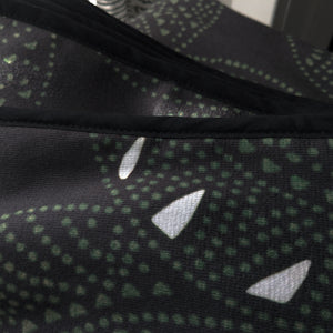Microfiber and cotton terry towel with a black and green abstract circular ‘Fiesta’ pattern. Soft and absorbent. Hemmed edges.
