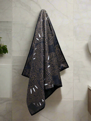 Black and yellow microfiber and cotton terry towel featuring a bold circular ‘Fiesta’ pattern.