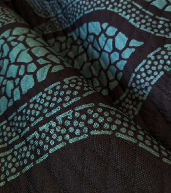 Rhythm Teal/Black Quilted Throw Blanket