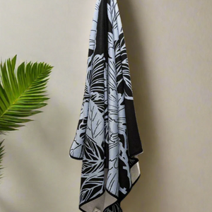 Microfiber and cotton terry towel with a black and light blue peony floral pattern.