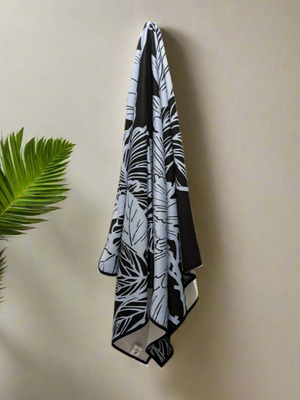 Microfiber and cotton terry towel with a black and light blue peony floral pattern.