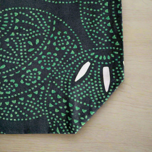 Black and green Everyday Tote Bag featuring a dynamic, abstract circular pattern. Made from organic cotton canvas.
