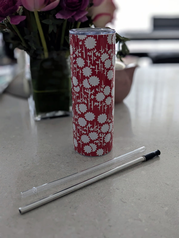 Stainless steel 20 oz tumbler adorned with a bold red floral pattern on a cream-colored background. Comes with a clear lid and two reusable straws for everyday use.