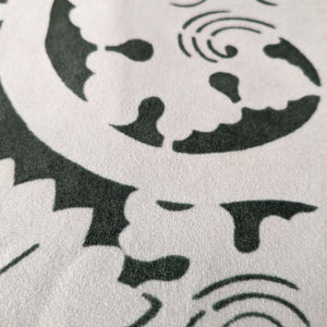 Modern black and white soft velvet pillow showcasing a bold floral stencil pattern with Japanese design influences.