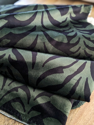 Sherpa blanket ruffled up on wooden table