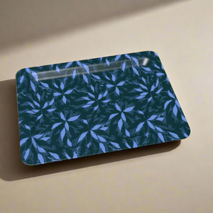 A decorative tray with a repeating blue and light purple floral motif, bathed in soft lighting.