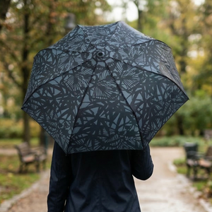 Umbrella featuring a dense pattern of stylized bamboo foliage in light blue-grey against a dark blue-grey background.