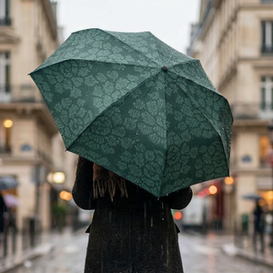 Dark green umbrella featuring a lighter green katagami-inspired peony motif.