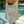 Light green and white towel featuring a stylized pattern of irregular vertical stripes and abstract circular shapes with small dots, evoking water or bubbles.