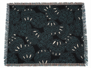 Patterned throw blanket with geometric design on a black background