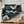 Decorative blanket with geometric pattern draped over a sofa in a living room setting.