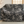 Decorative throw blanket with intricate black and white pattern featuring koi fish, draped over a sofa.
