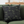Green sofa with a decorative pillow and blanket in a living room setting.