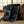 Dark patterned throw blanket draped over a wooden chest in a room with tatami flooring.