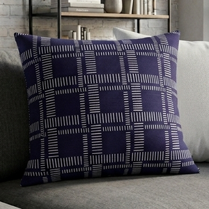 Gray sofa with a blue patterned pillow in a modern living room.