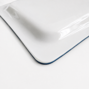 Close-up of the white underside of this rectangular, plastic serving tray.